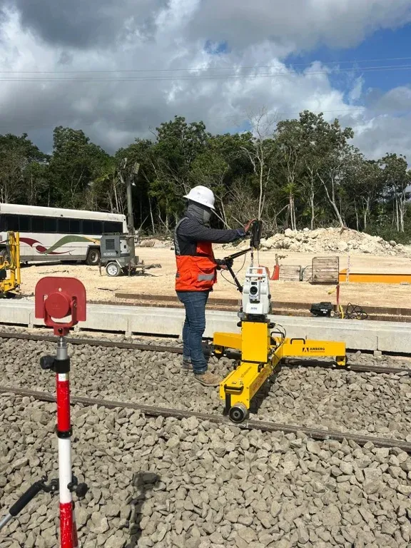 Carro de medición en vía junto a plataforma de obra